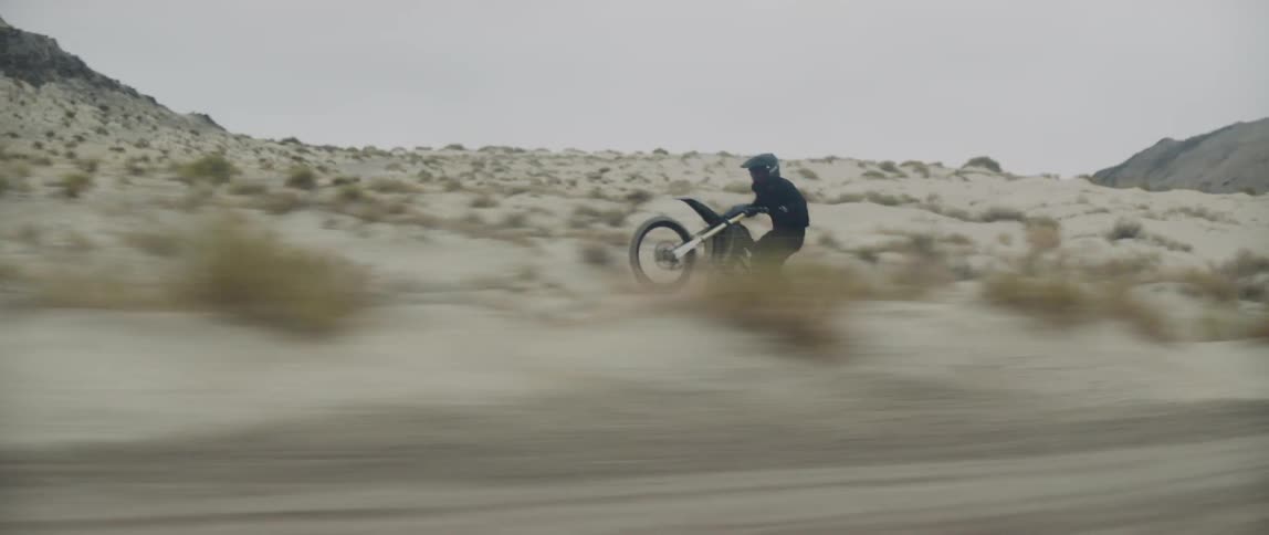 A man riding a dirt bike outdoors fast