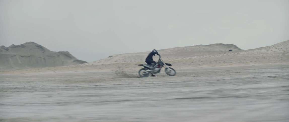 Man riding an off road motorcycle doing stunts in the desert