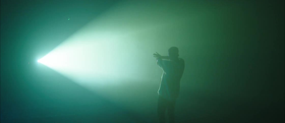 A man looking at a laser on a stage