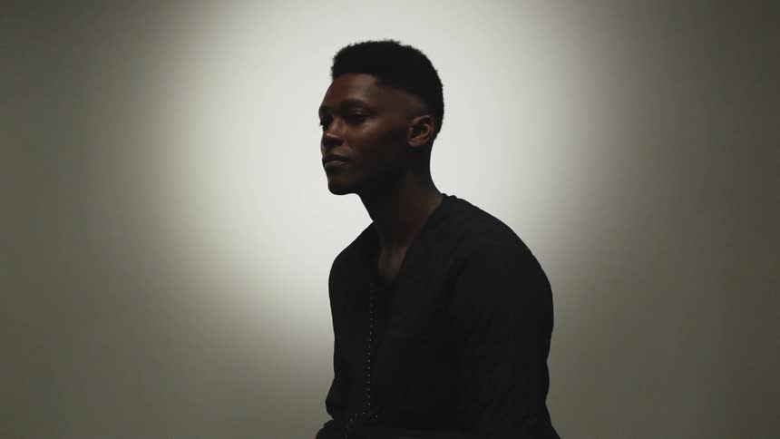 A man is sitting in an empty room