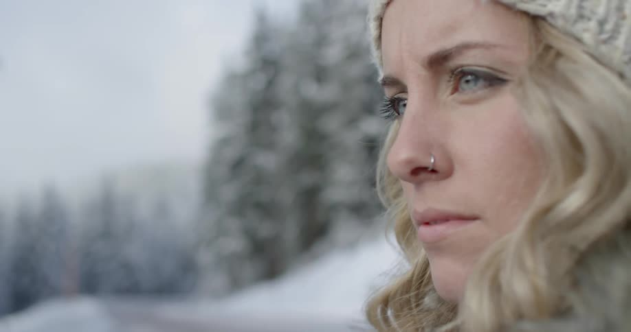 A woman looks forward with snow all around