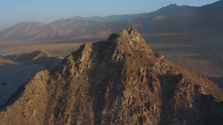 An aerial view of a mountain and desert area