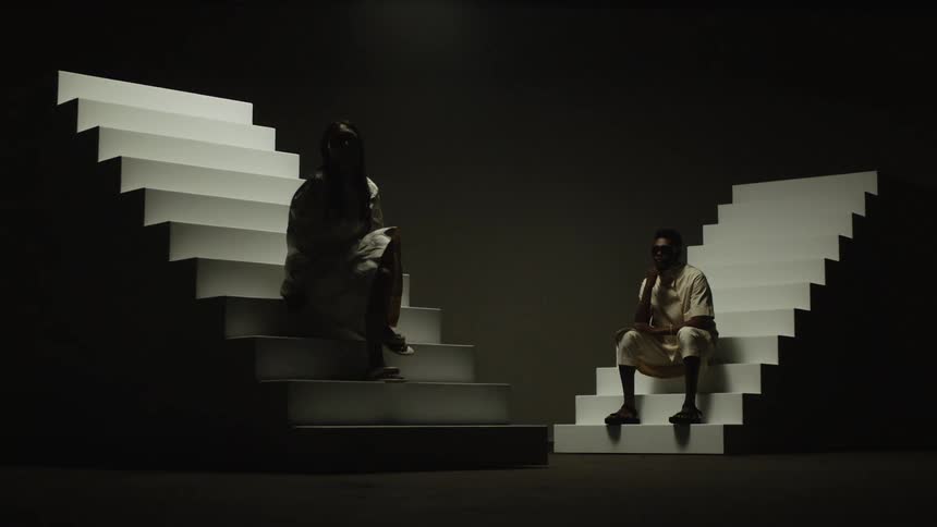 Man and woman are sitting on staircases