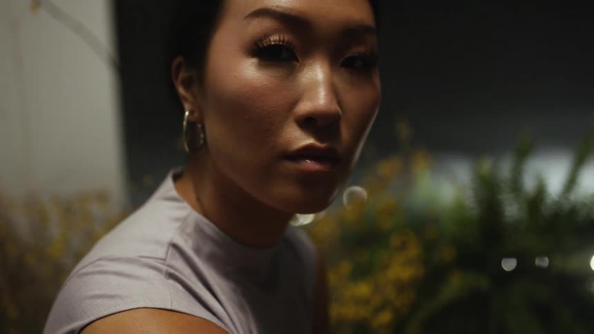 A woman turning and looking at a camera