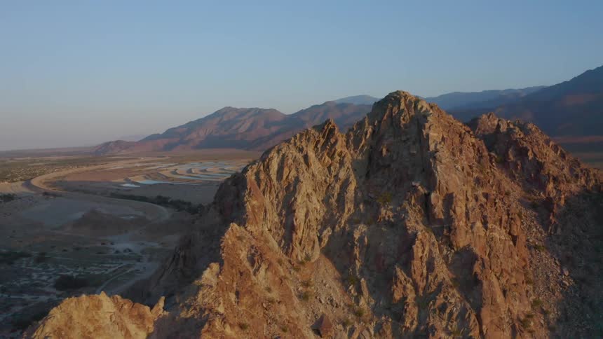 Aerial view of mountain range at dusk is displayed