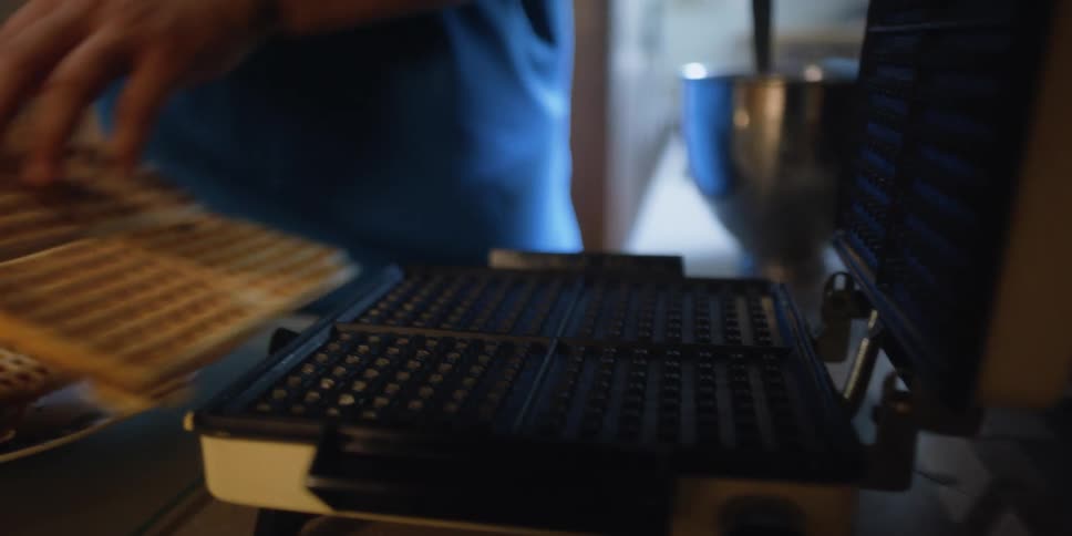 A man cooking waffles