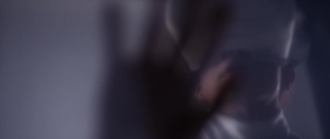 A woman in a room with a vr headset with a wall in the background