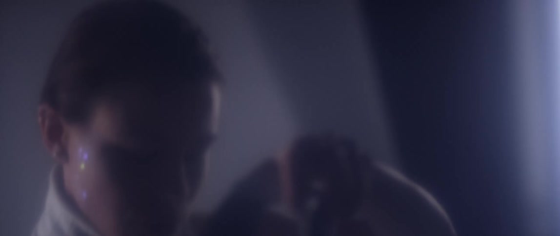 A woman in a room putting on a vr headset with curtains and a window in the background
