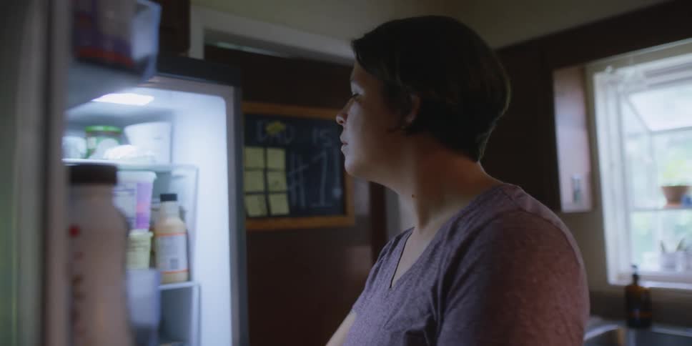 A woman looking through a refrigerator