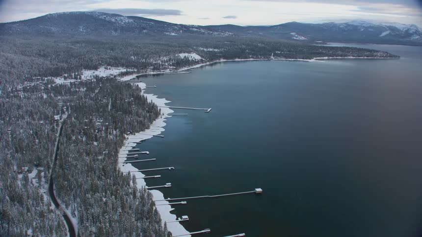 Aerial view of piers on a lake near the mountains at winter