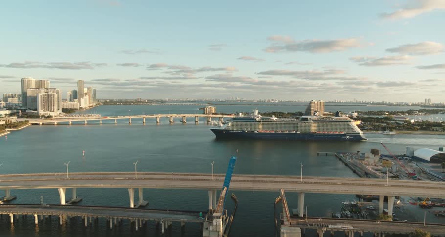 Aerial view of boats are shown in the ocean water at dusk