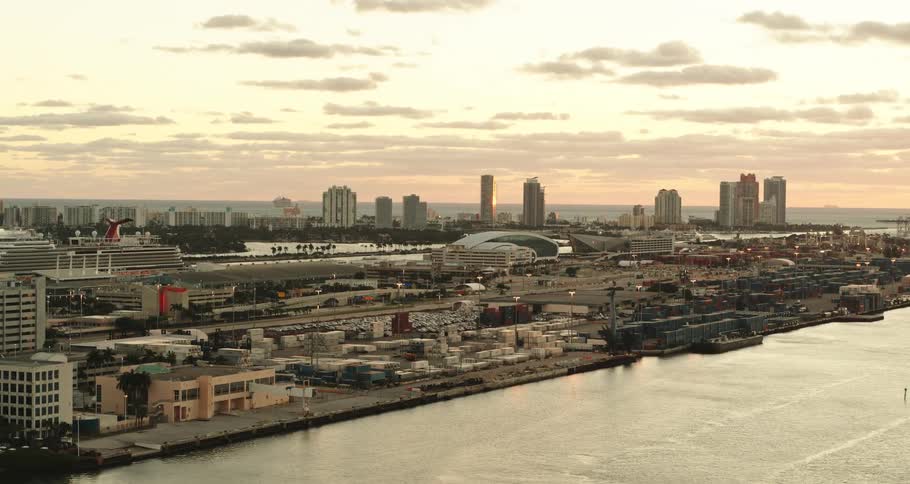 Office buildings and condos fill the skyline of a downtown city along the sea