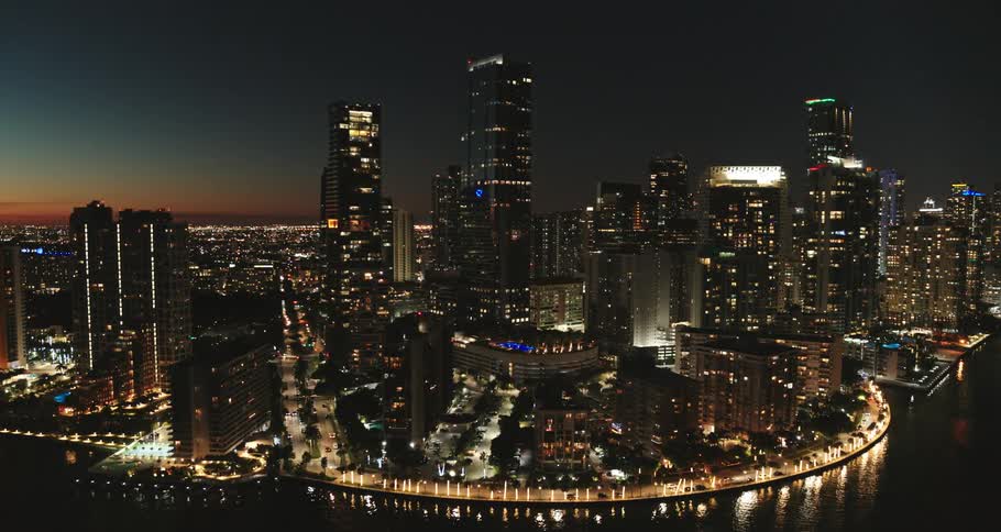 Aerial view of illuminated city with tall buildings at night