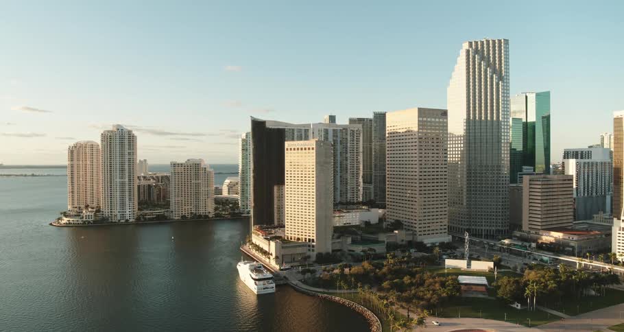 Aerial view of a downtown city next to an ocean is displayed