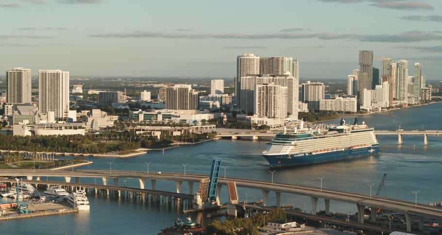 Aerial view of a city near an ocean is displayed