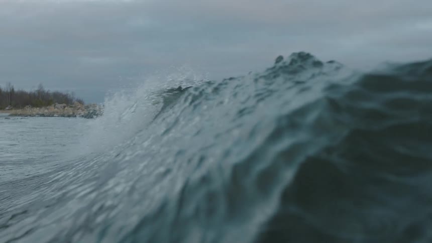 A wave breaks and rolls past the camera