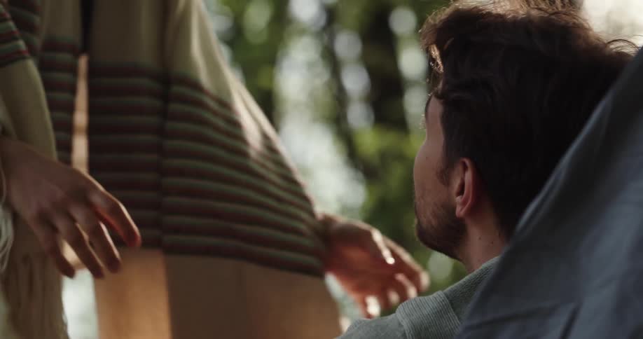 Husband and wife are outdoors and kissing