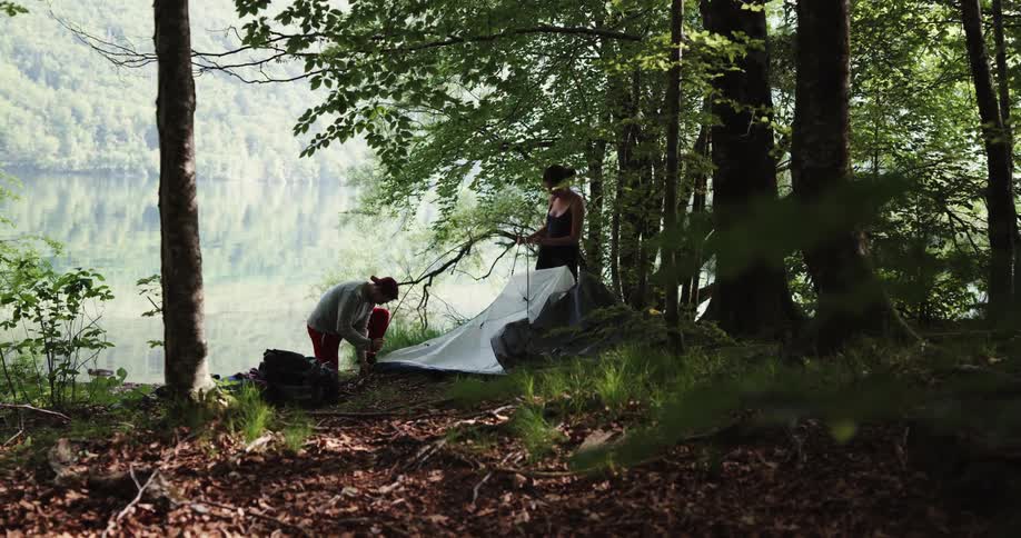 Male and female putting up a tent