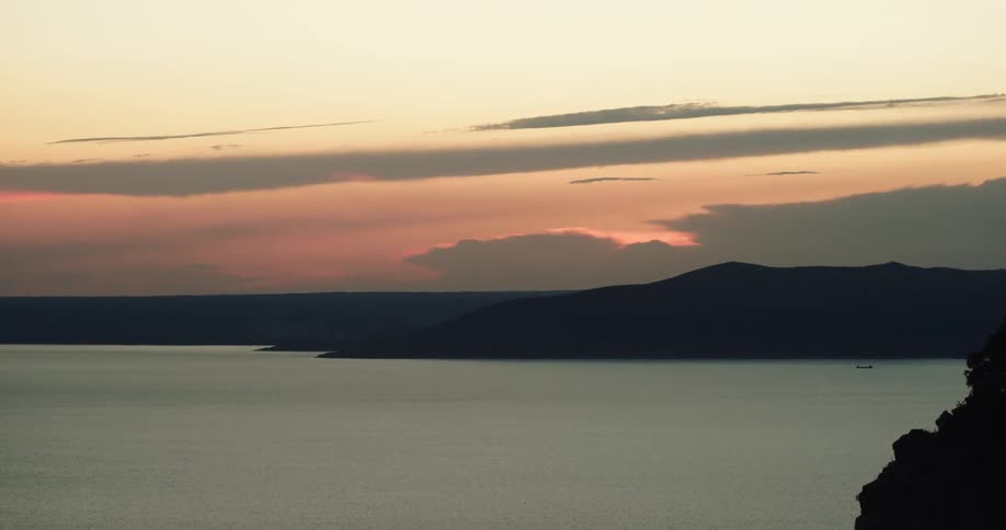 A landscape view of a boat in the lake as the sun sets