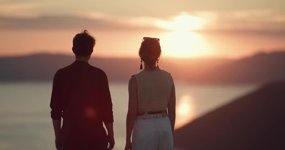 A couple watch the sunset together