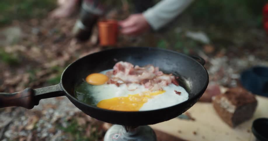 A person is cooking in the wilderness outdoors