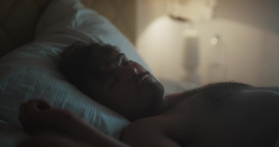 A man is sleeping in bed