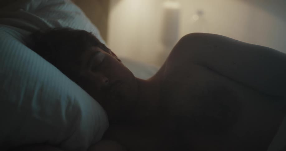 A man sleeping in a bed