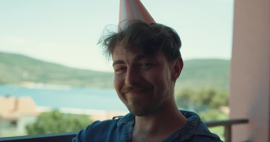 A man is celebrating his birthday and drinking a glass of wine