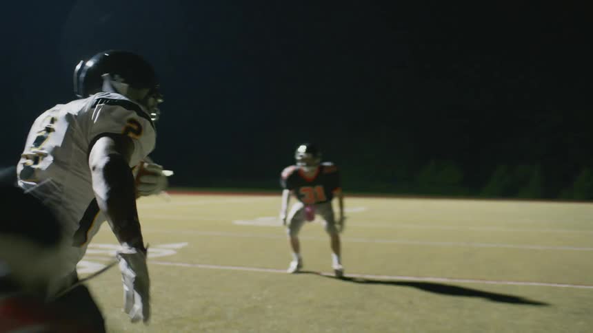 A player rushes down the field moving past other players with the ball