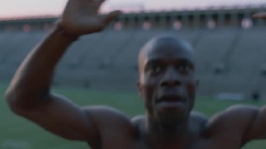 Man doing exercises in an empty stadium