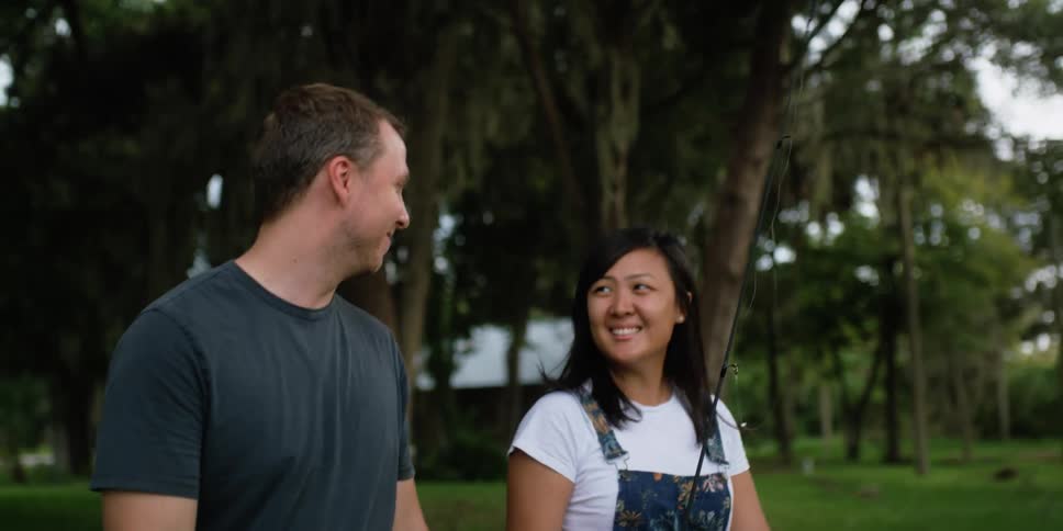Happy couple walking and talking on a park at daytime