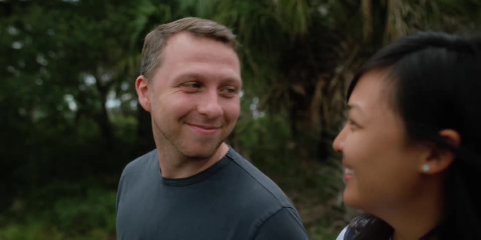 A man and woman walking around outdoors