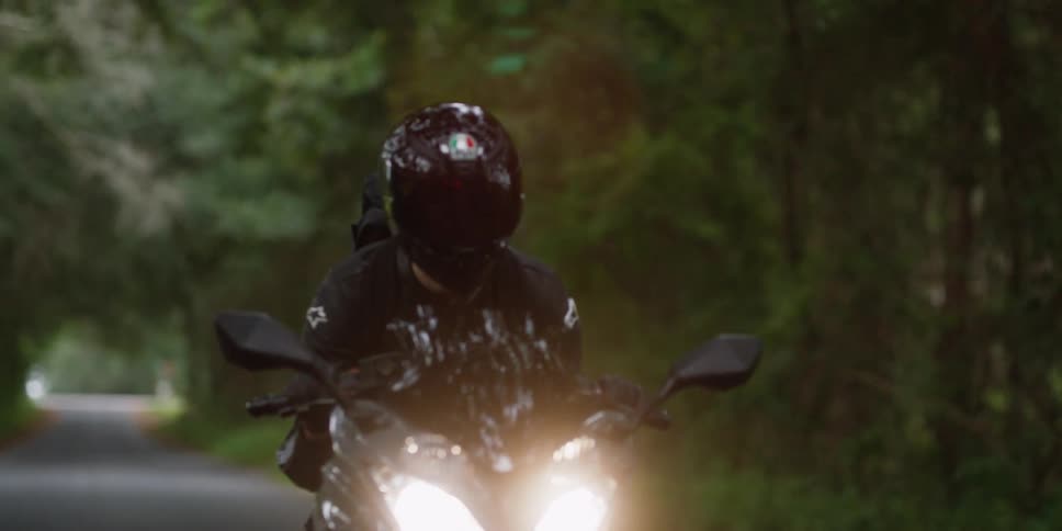 A motorcycle rides down the small road