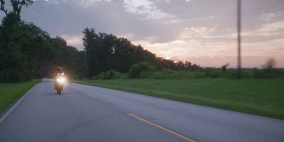 A person is riding a bike during evening time