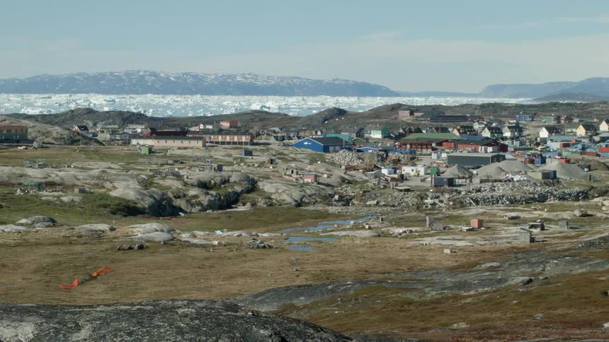 View of a town at the edge of an icy body of water