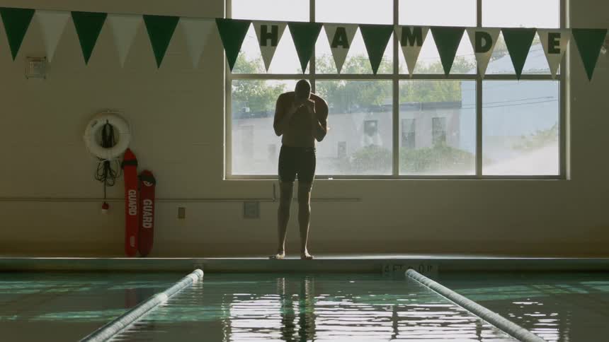 A man diving into an indoor pool