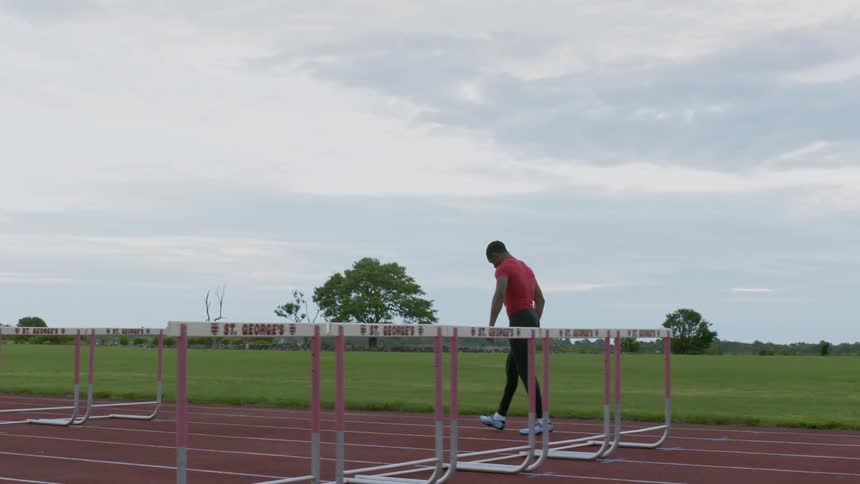 Man walking along a running track
