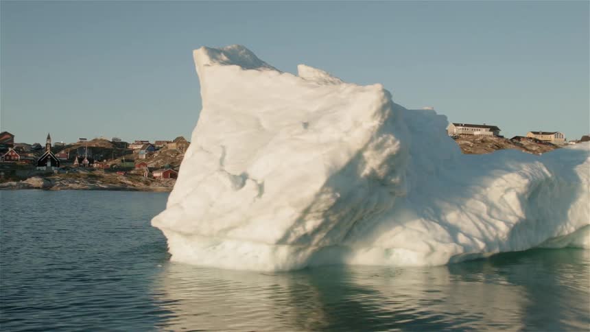 Icebergs float in the water near the coast