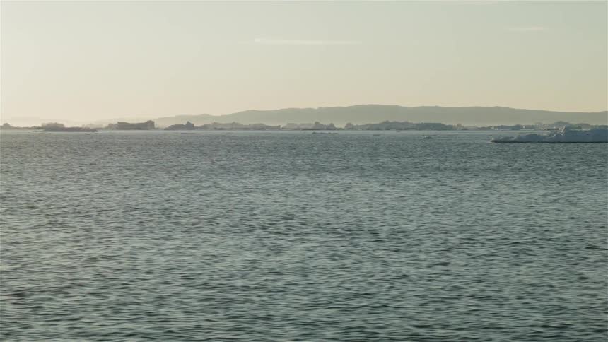 A wide expanse of water on a mostly clear day