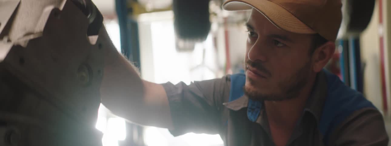 A mechanic examines a part