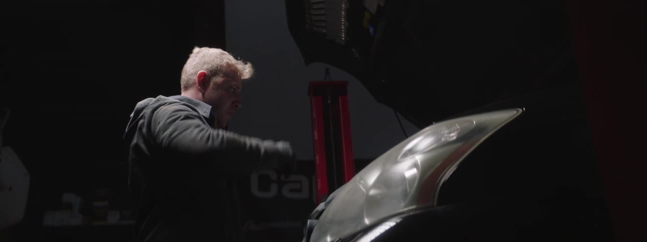 A man looking inside a car