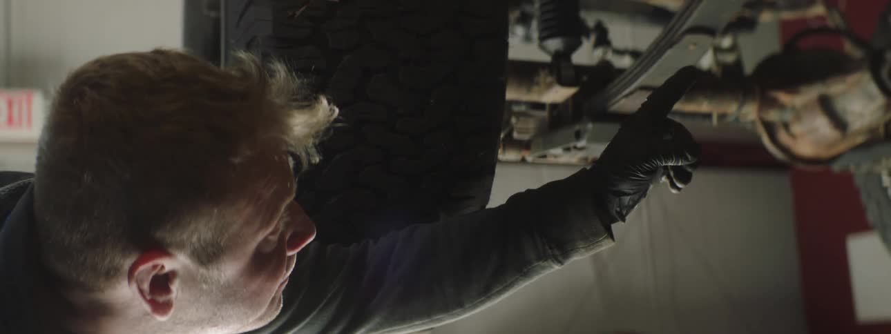 Mechanic looking at car