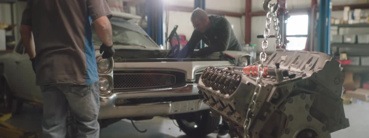 Two men working on a car