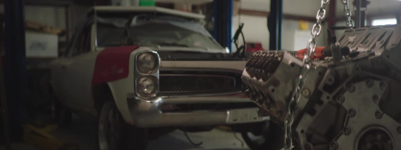 An old car sits in a garage