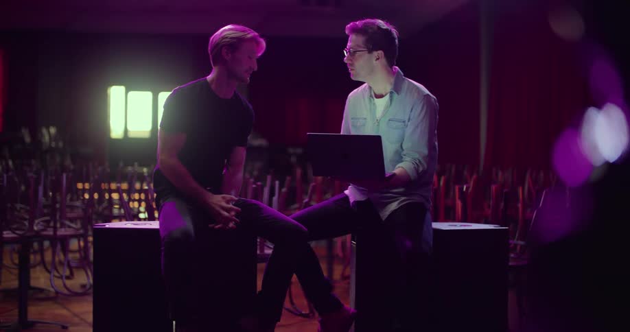 Two men sitting in a room talking with each other