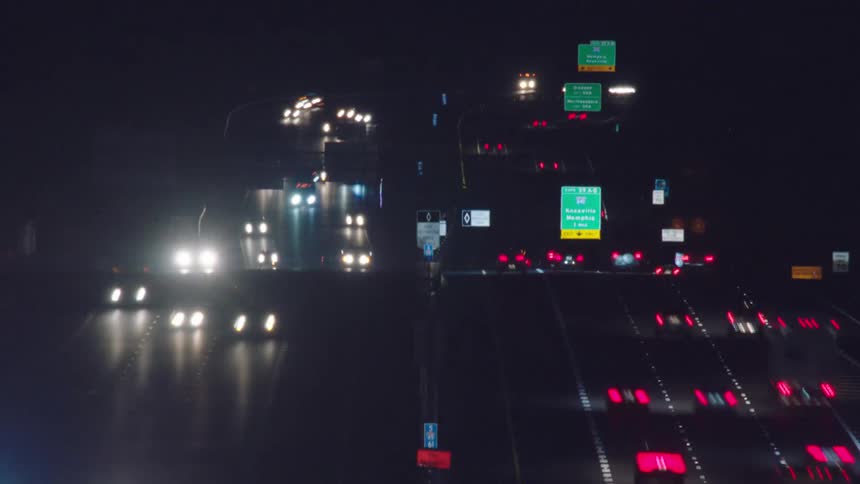 Vehicles travel on the freeway at night
