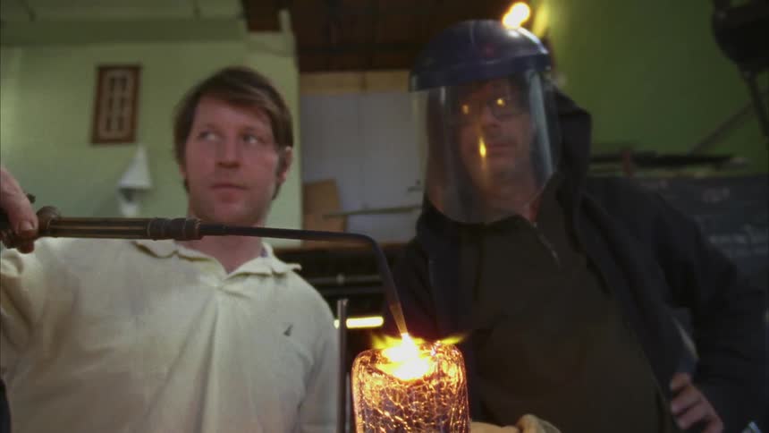 Two men are working together welding something