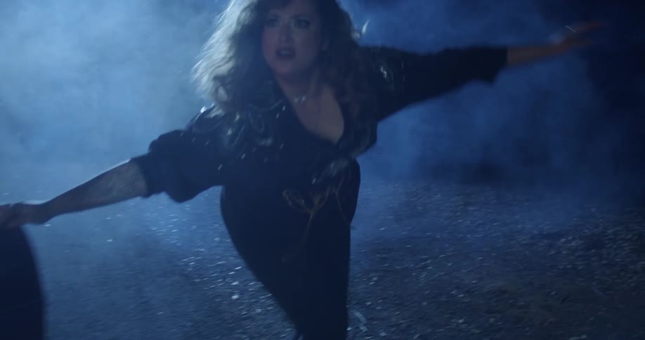 A scared woman exits the vehicle on a foggy night