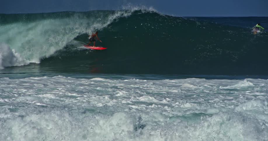 A man is surfing a large wave