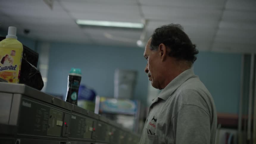 A man puts a coin in a machine